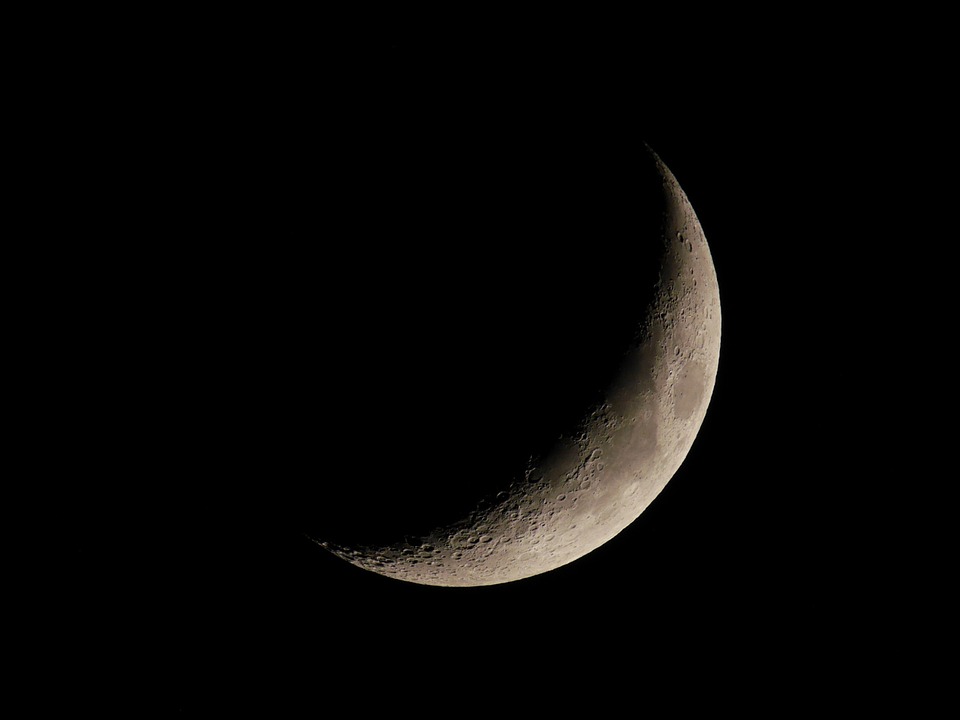 black and white photo of a crescent moon 